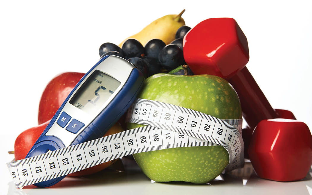 Blood sugar control glucometer for glucose level with healthy organic food and dumbbells with measuring tape on a white background  Healthy lifestyle, detox, weight loss and Diabetes concept