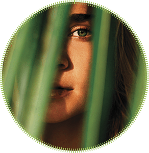 portrait of tender woman looking out of palm leaf Bali Indonesia
