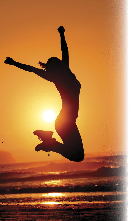 Successful woman jumping, dancing and having fun on sunset in beach. Freedom and happiness concept. Girl celebrating work out success.