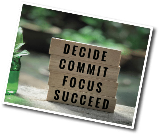 Motivational and inspirational quote - ‘Decide, commit, focus, succeed’ written on wooden blocks. With vintage styled background.