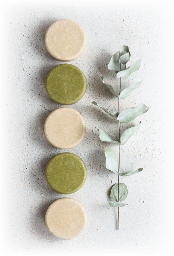 Eco friendly solid handmade colorful shampoo bars on light colored background top view. Hair care from nature. Zero waist without plastic.