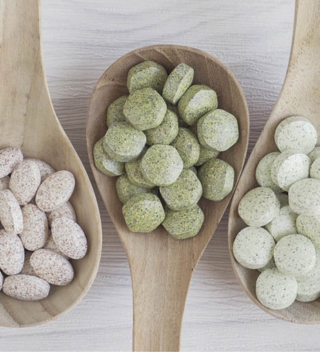Natural cruciferous vegetables and alternative herbal tablet pills in wooden spoons, keto diet dietary supplements for healthy gut; Shutterstock ID 1765573250; Purchase Order: COG