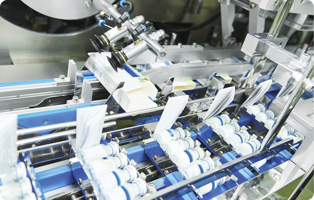  pharmaceutical industry. Line machine conveyer for packaging glass bottles ampoules in boxes at factory 