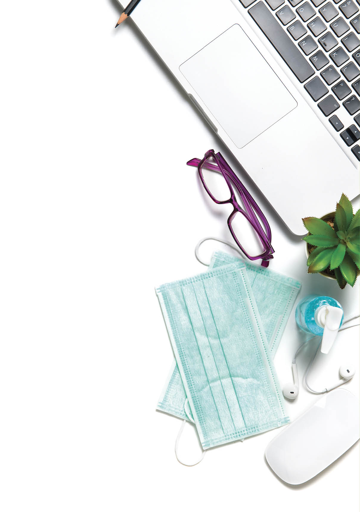 White office desk table with surgical face mask and sanitizer bottle or alcohol gel with laptop isolated on white background, work from home and covid-19 concept and new normal