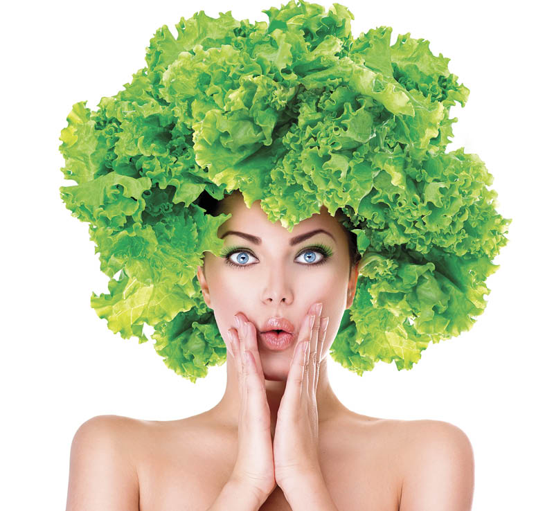 Surprised model girl with Lettuce hair style. Beautiful happy young woman with green vegetables on her head. Healthy food concept, diet, vegetarian food. Dieting concept. Weight loss. Vegan food