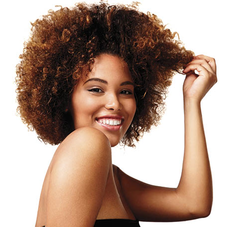 woman with natural makeup, afro hair is laughing