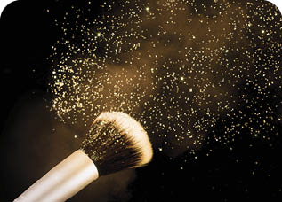 golden glittering blusher explosion isolated on black background