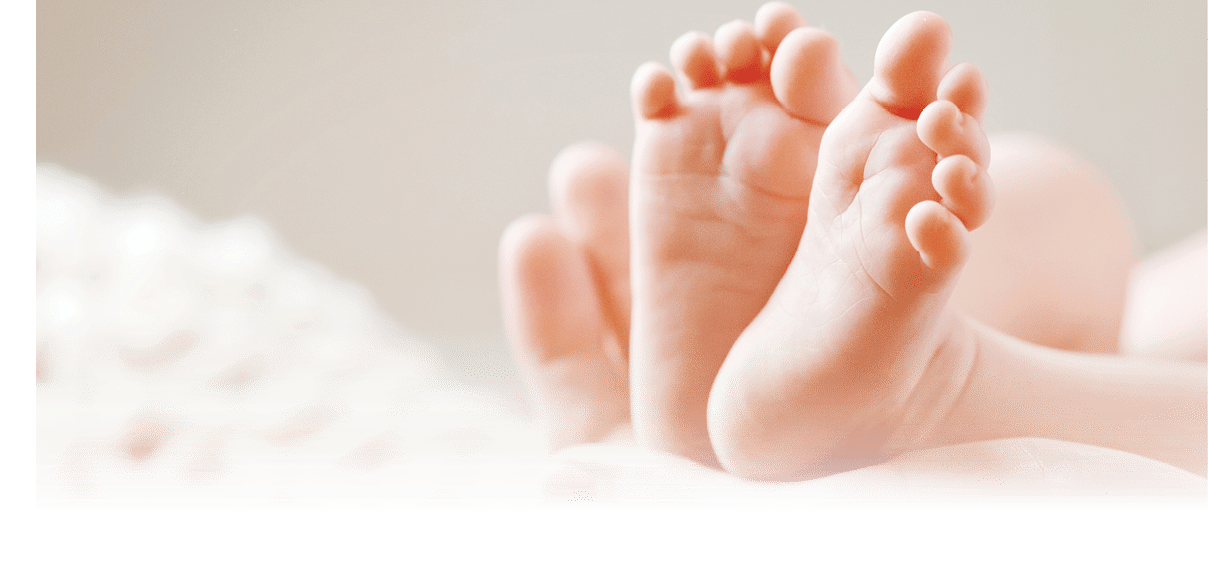 Baby feet in mother hands. Mom and her Child. Happy Family concept. Beautiful conceptual image of Maternity