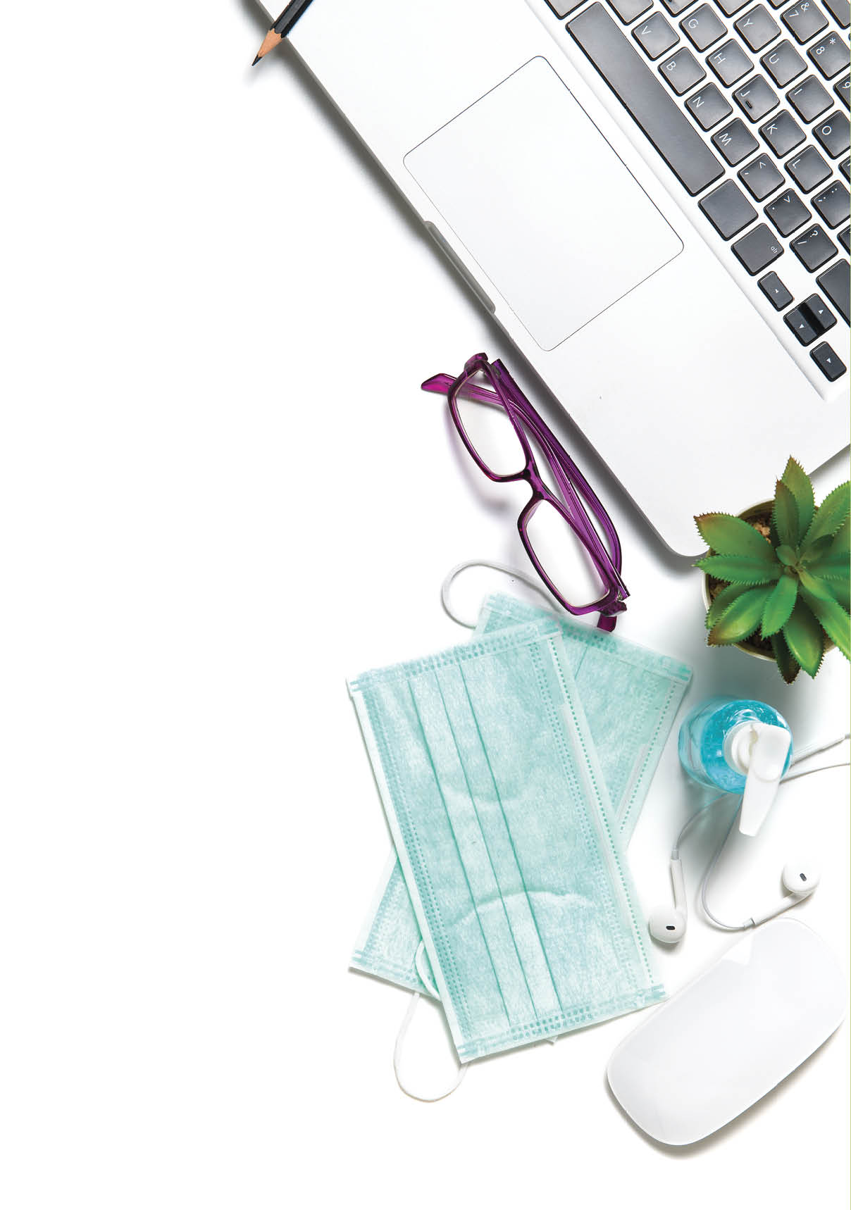 White office desk table with surgical face mask and sanitizer bottle or alcohol gel with laptop isolated on white background, work from home and covid-19 concept and new normal