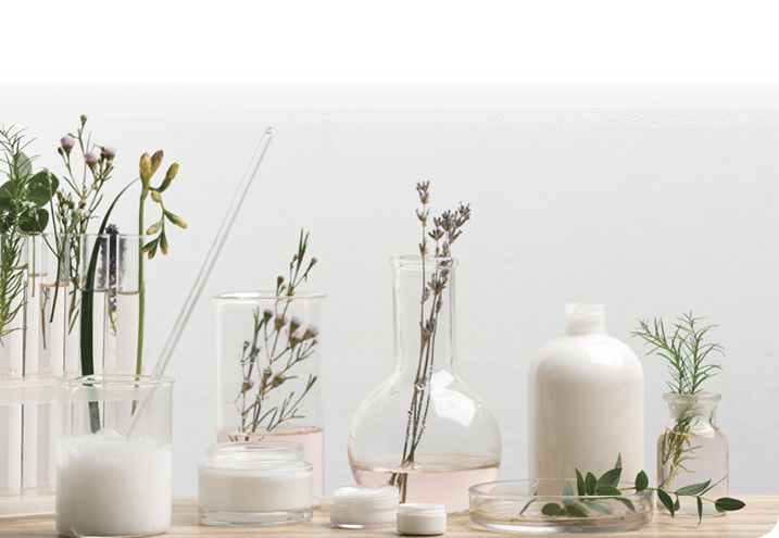 Herbal cosmetic products, laboratory glassware and ingredients on wooden table