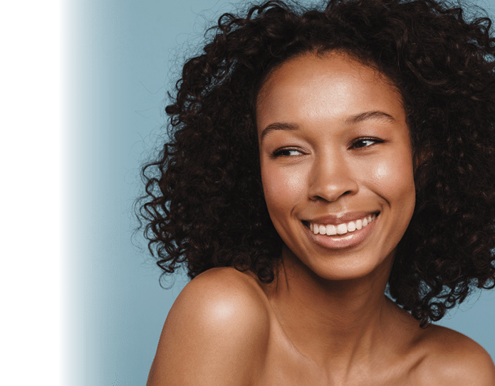 Shirtless black woman looking aside and laughing isolated over blue background