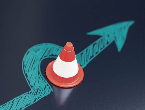 Chalk drawing arrow turn or break through road block traffic pylon on dark blackboard using as obstacle, solution for business problem or break through to success concept.