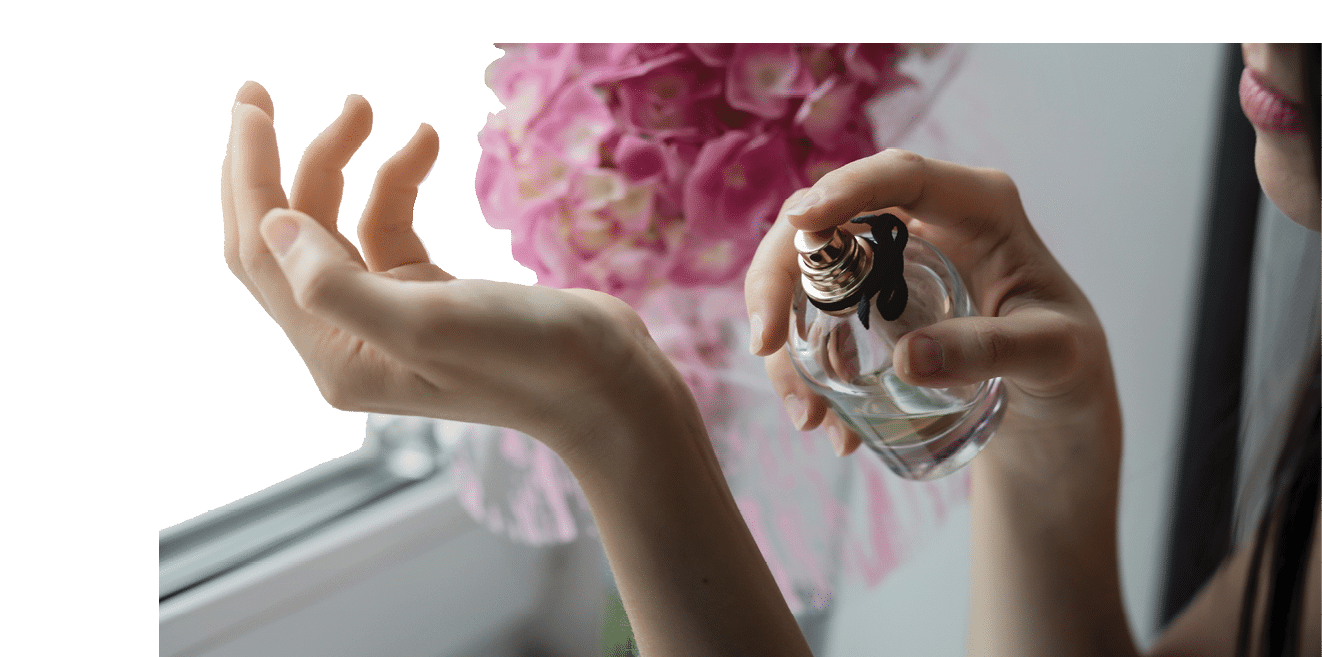 Woman applying perfume on her wrist. Perfume bottle female spray
