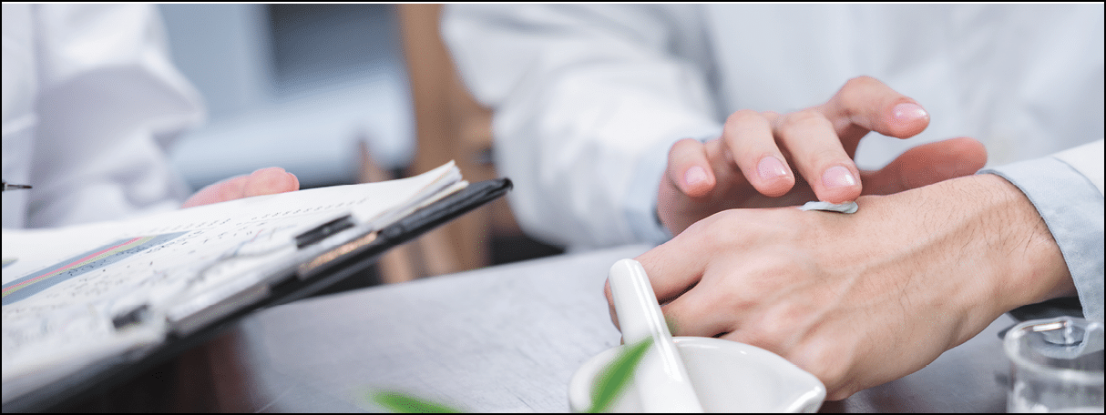Beauty cosmetic research and development concept, Pharmacist and Scientist applying moisturizer lotion on her hand for efficacy testing of natural organic skincare products in biological laboratory