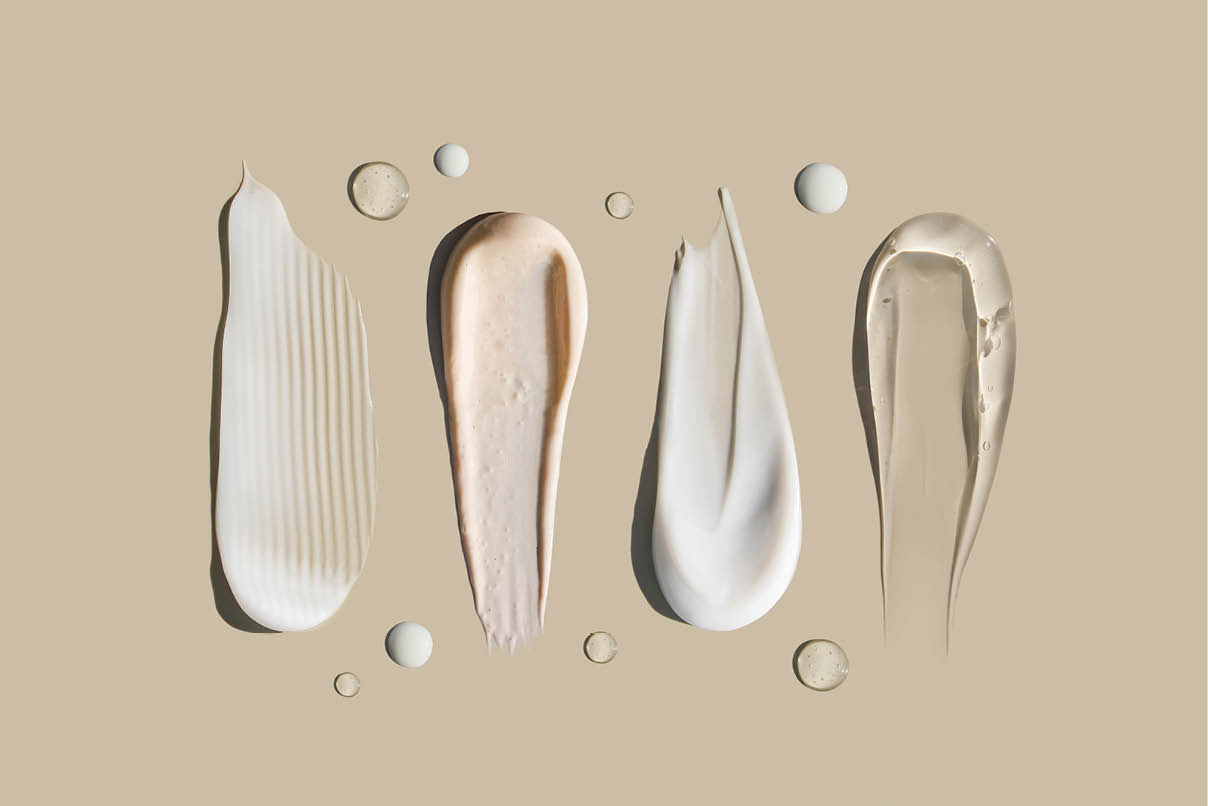 cosmetic smears of creamy texture on a pastel background