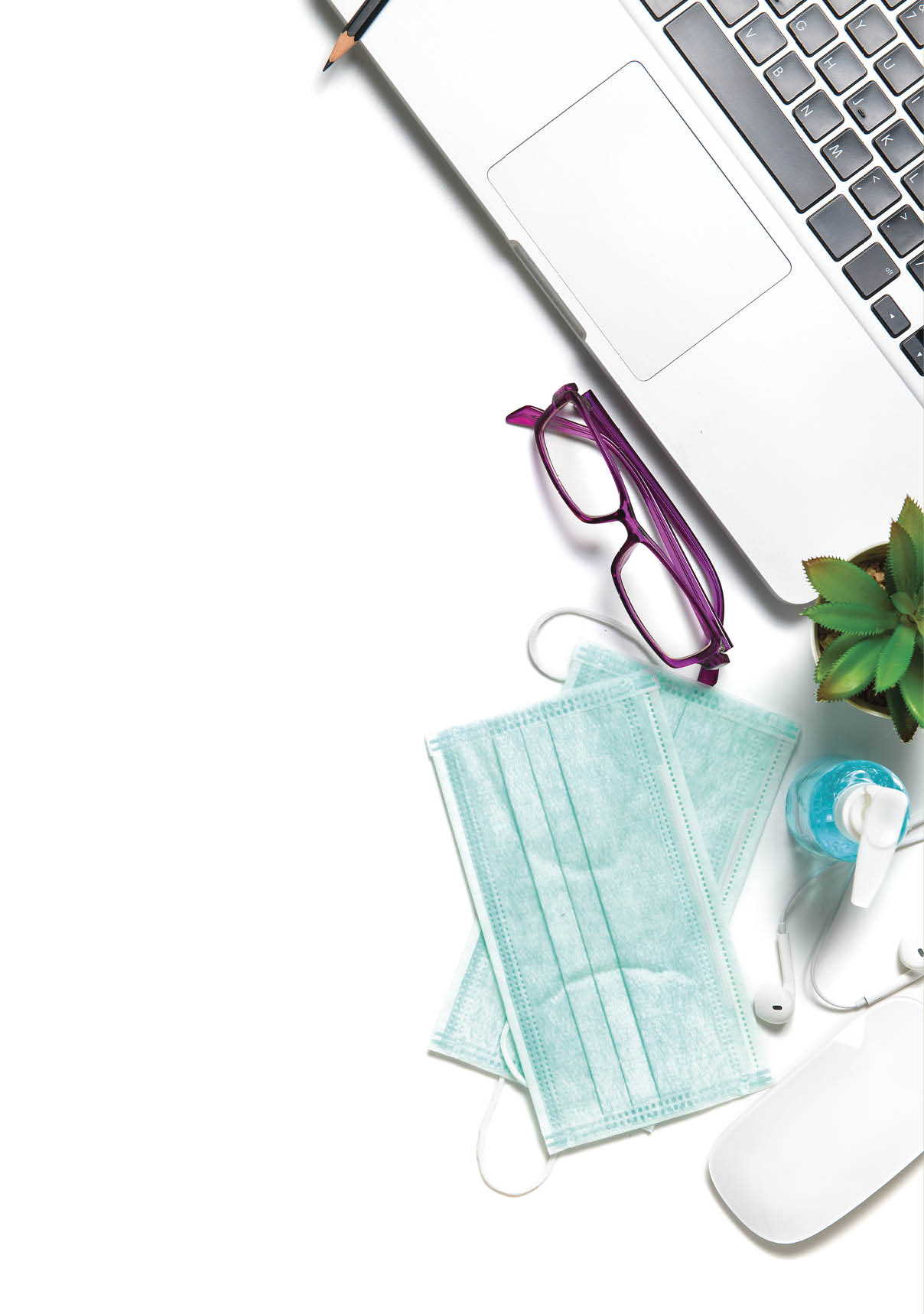 White office desk table with surgical face mask and sanitizer bottle or alcohol gel with laptop isolated on white background, work from home and covid-19 concept and new normal