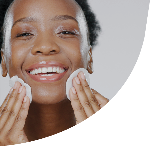 Woman, model and cotton pad on face with skincare, toner and happiness in advertisement, cosmetics and studio. Black lady, glowing skin and dermatology for cleanser, wipe and beauty with aesthetic