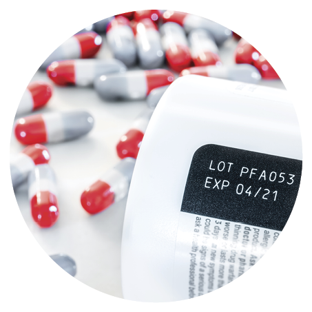 Expired date and lot number label printed on medicine bottle with blurred background of pile of painkiller pills awareness expiration information on packaging from the manufacturer. Medication.