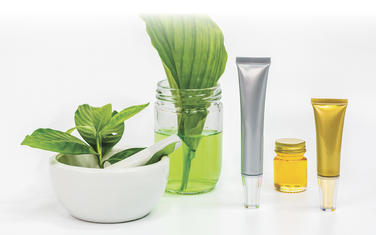 Herbal natural organic skin care serum with plant in white mortar bowl.